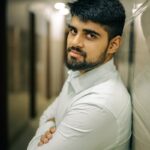 A man leaning against a wall with his arms crossed