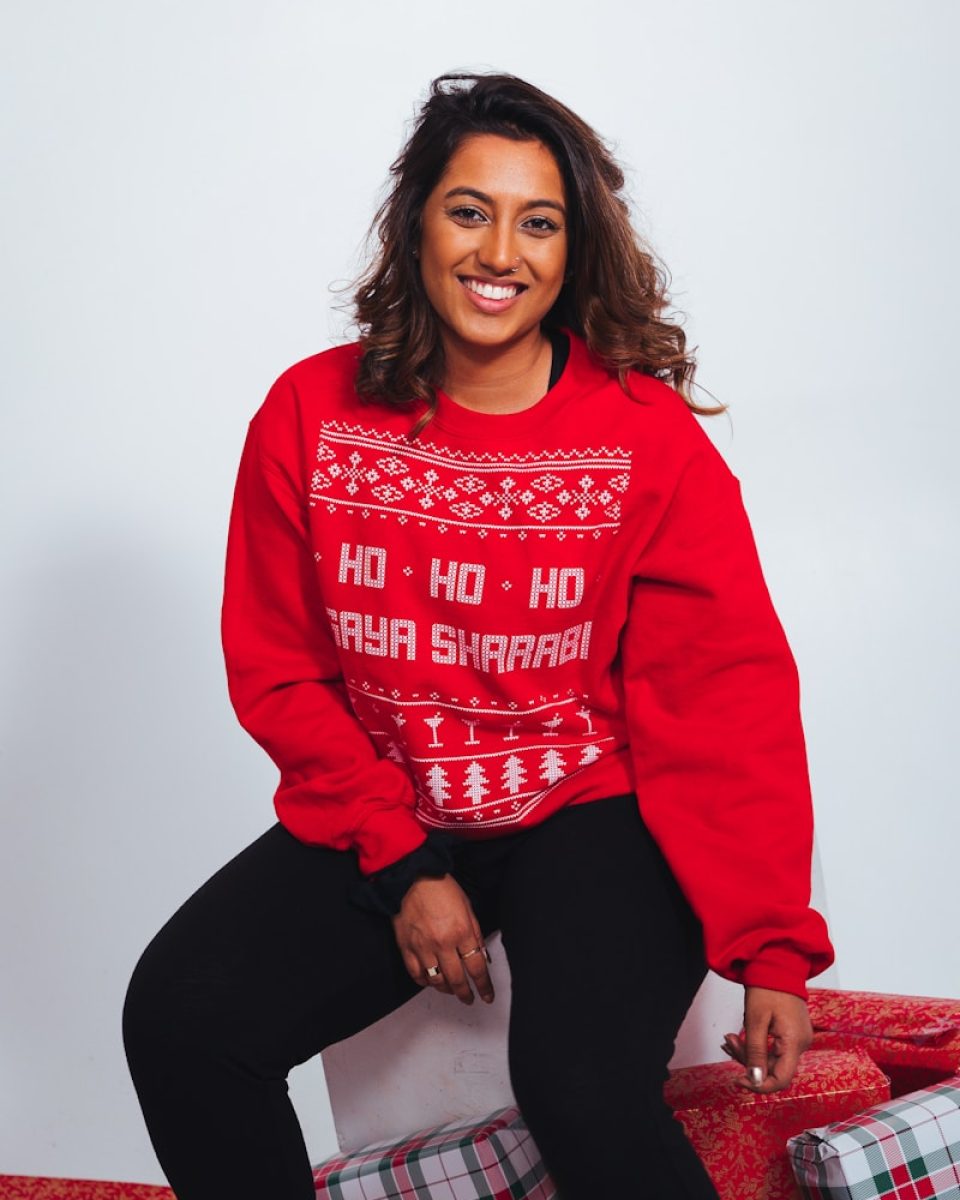 Photo by NONRESIDENT woman in red sweatshirt and black pants