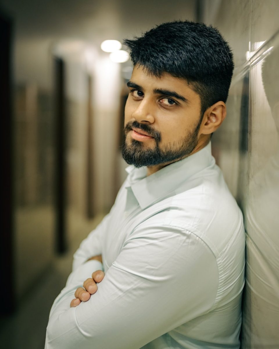 Photo by Sanju Pandita A man leaning against a wall with his arms crossed